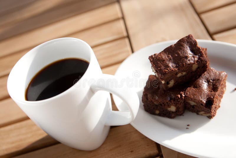 Coffee with chocolate brownie on side. stock photo