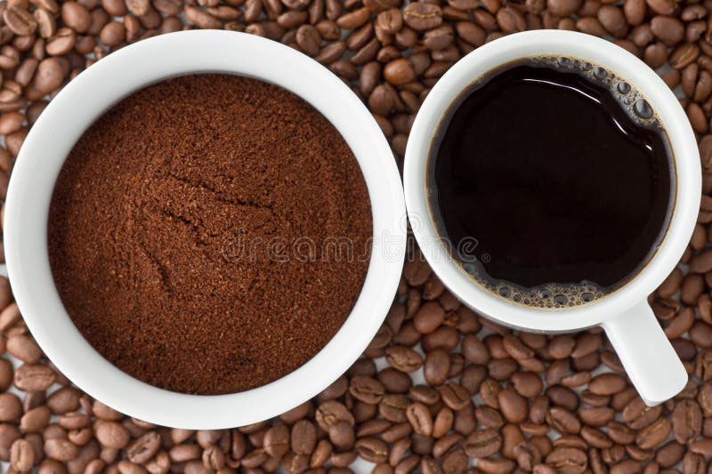 Coffee and coffee powder on top of coffee beans