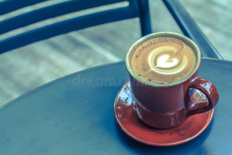 Coffee cup on black metal table in coffee shop. stock images Coffee cup on black metal table in coffee shop. stock images
