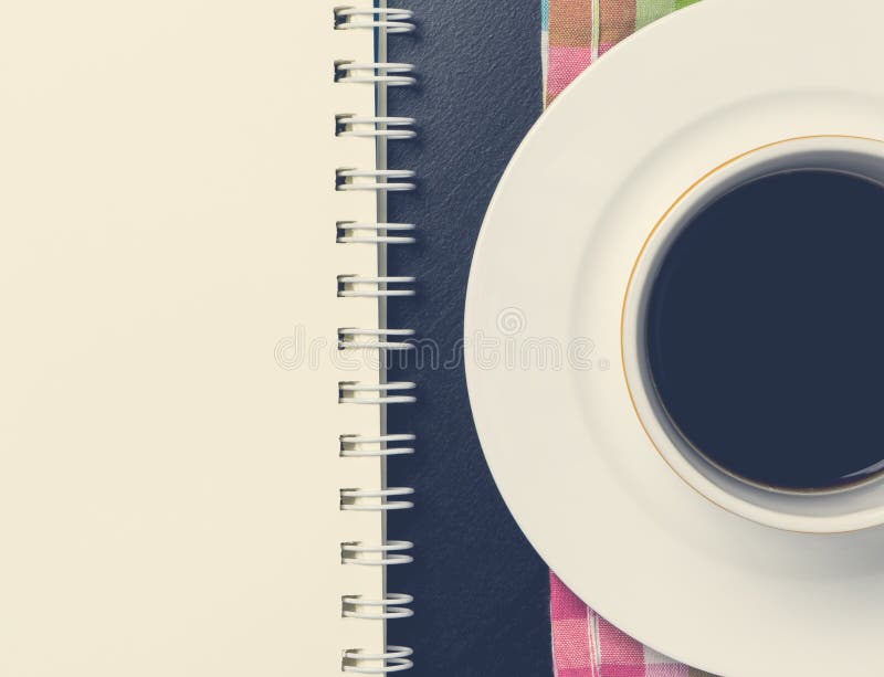 Coffee cup with blank notebook office supply