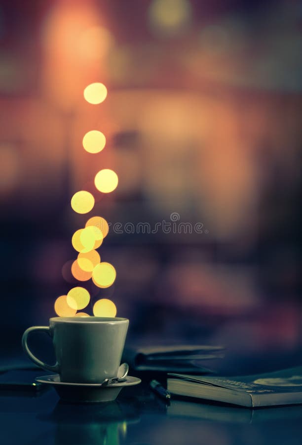 Coffee cup and blurred lights