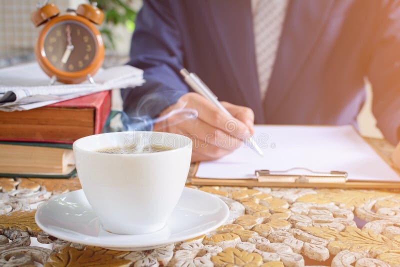 coffee cup clock and newspaper work on table the good morning