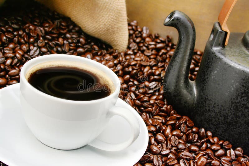 Coffee cup close-up over roasted beans