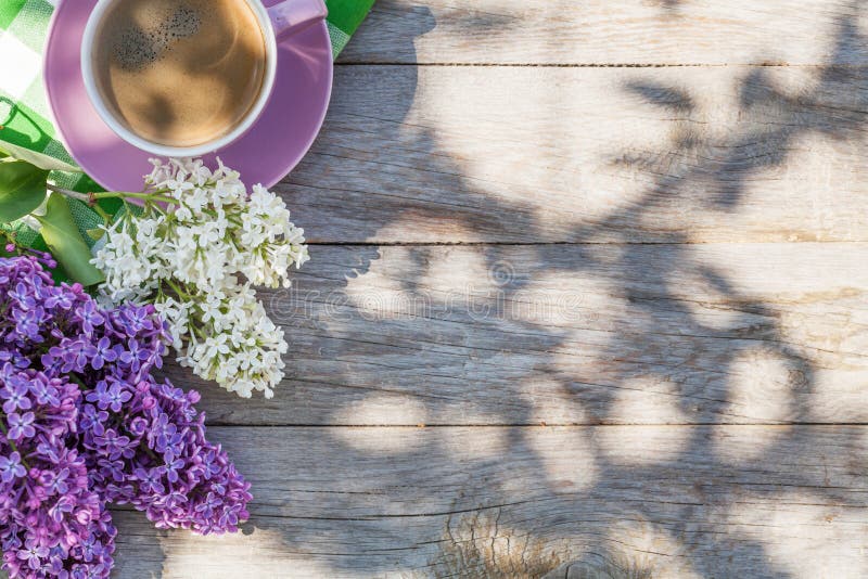 Coffee cup and colorful lilac flowers on garden table royalty free stock images Coffee cup and colorful lilac flowers on garden table royalty free stock images