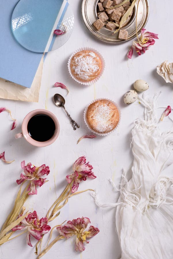 Coffee cup, cupcakes with pink tulip flowers on white rustic table from above, breakfast on Mothers day or Women's day. stock photos Coffee cup, cupcakes with pink tulip flowers on white rustic table from above, breakfast on Mothers day or Women's day. stock photos