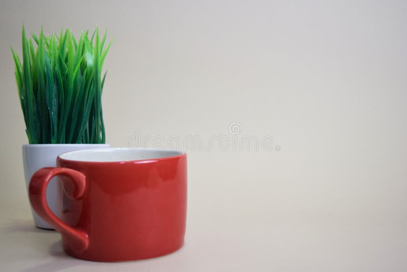 Coffee cup and grass pot isolated on brown background royalty free stock photos Coffee cup and grass pot isolated on brown background royalty free stock photos