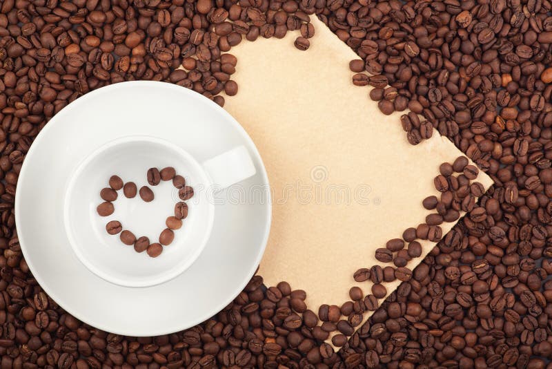 Coffee cup with heart symbol and paper