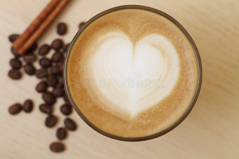 Coffee cup with milk and heart shape