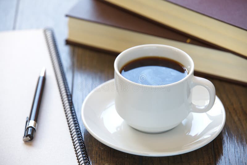 Coffee cup on a pile of books