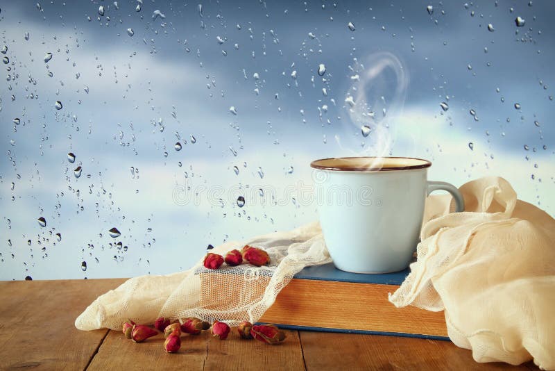 Coffee Cup On A Rainy Day Over Wooden Table And Window With Rain Stock