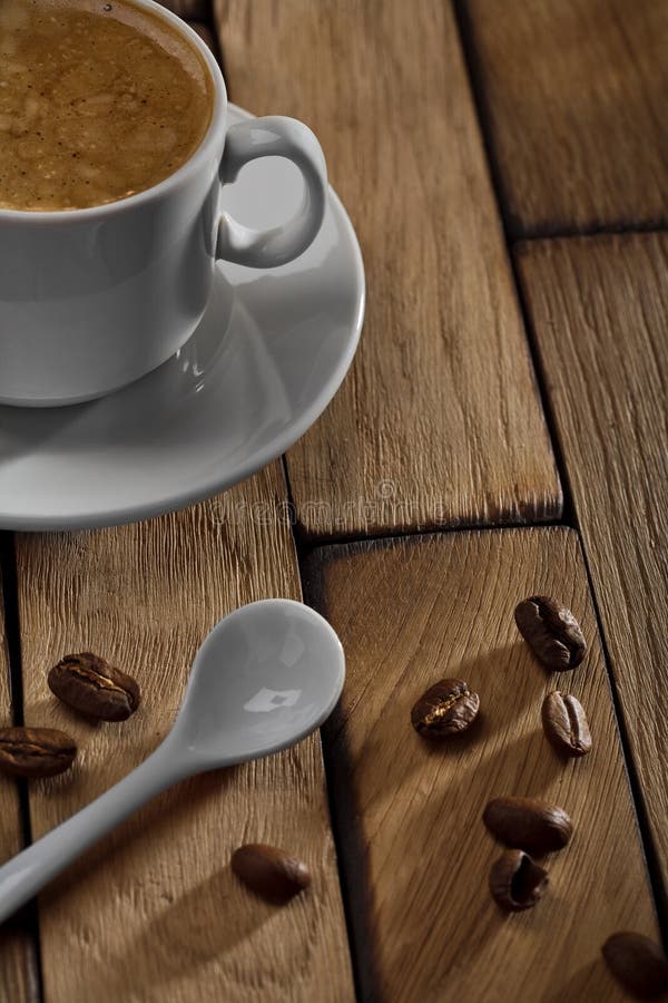 Coffee cup and spoon on wooden table