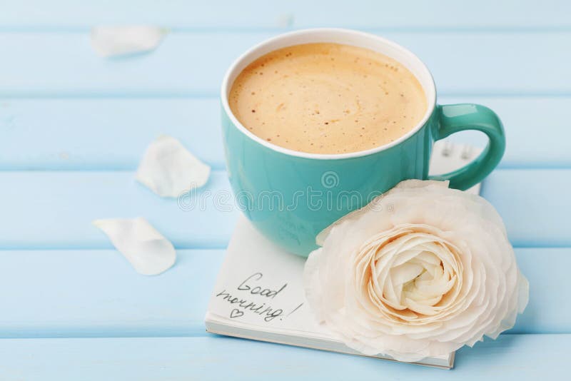 Coffee cup with spring flower and notes good morning on blue rustic background, breakfast stock image Coffee cup with spring flower and notes good morning on blue rustic background, breakfast stock image