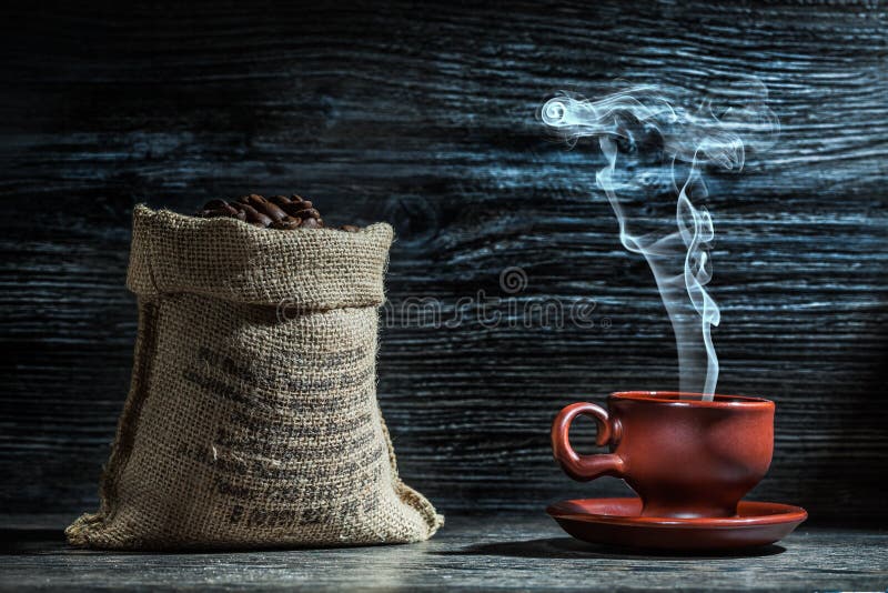 Coffee cup with steam and sack of beans