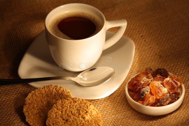 Coffee cup with sugar and fresh cookies