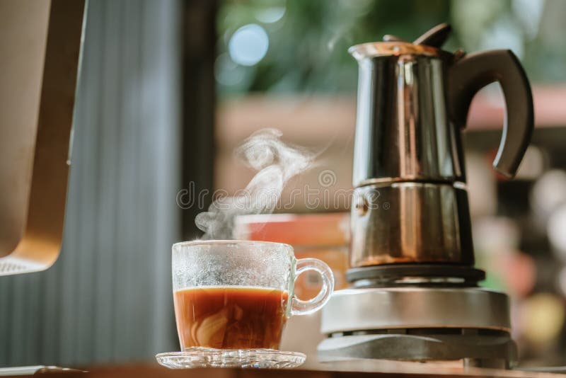 Hot Coffee in Moka Pot on Electric Stove ,vintage Coffee Maker on Wooden  Table at Home, Selective Focus Stock Image - Image of drink, brown:  239947361