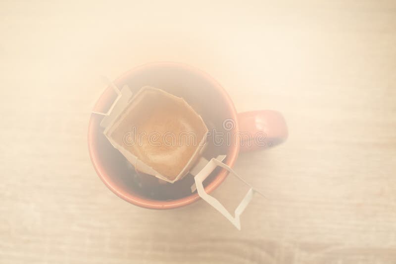 Coffee Drips in Cup. Alternative Brewing Coffee in Paper Filter Bags