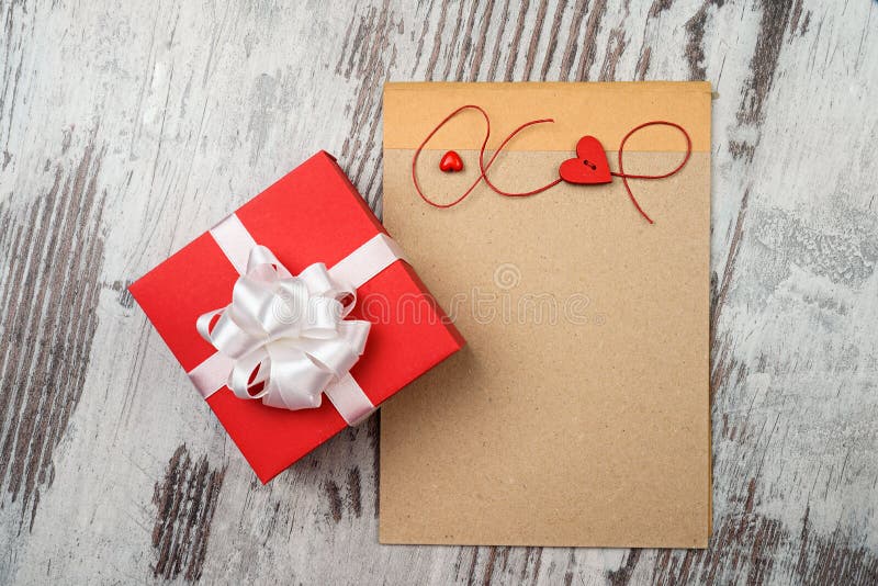 Coffee and empty notepad with red gift box