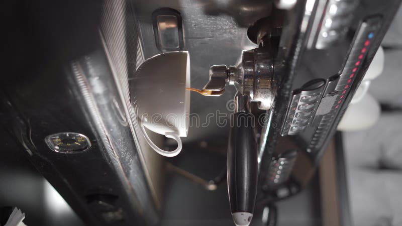 Coffee extraction from the coffee machine. Espresso pouring from coffee machine, close-up. stock video