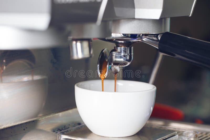 Coffee extraction pouring into a cup from professional coffee ma stock photos Coffee extraction pouring into a cup from professional coffee ma stock photos