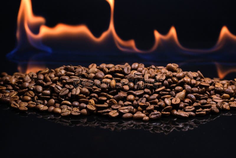 Roasting Coffee Beans with Fire on a Dark Background. Coffee Roasted