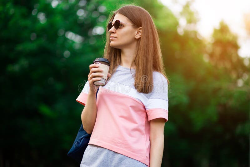 Coffee On The Go. Beautiful Young Woman Holding Coffee Cup And