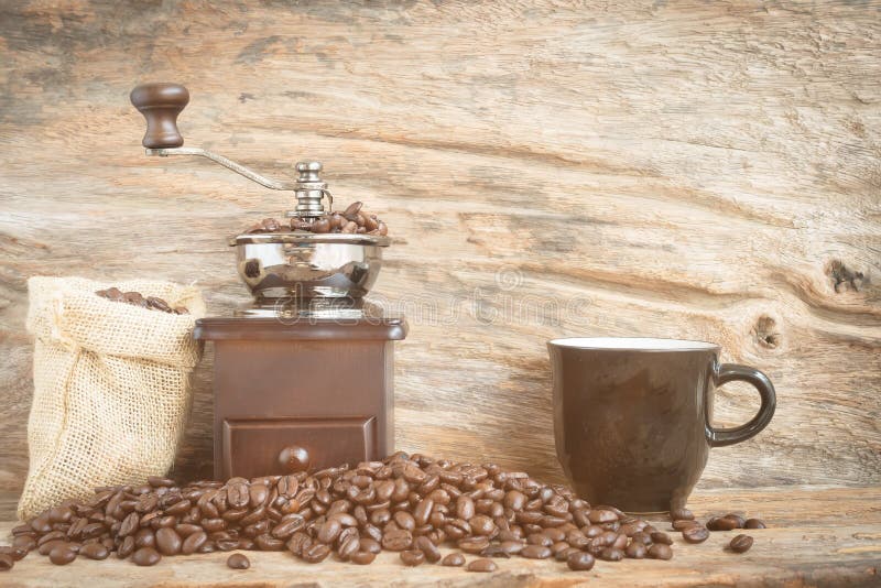 Antique Coffee Grinder And Coffee Bean On Wood Background Stock Image