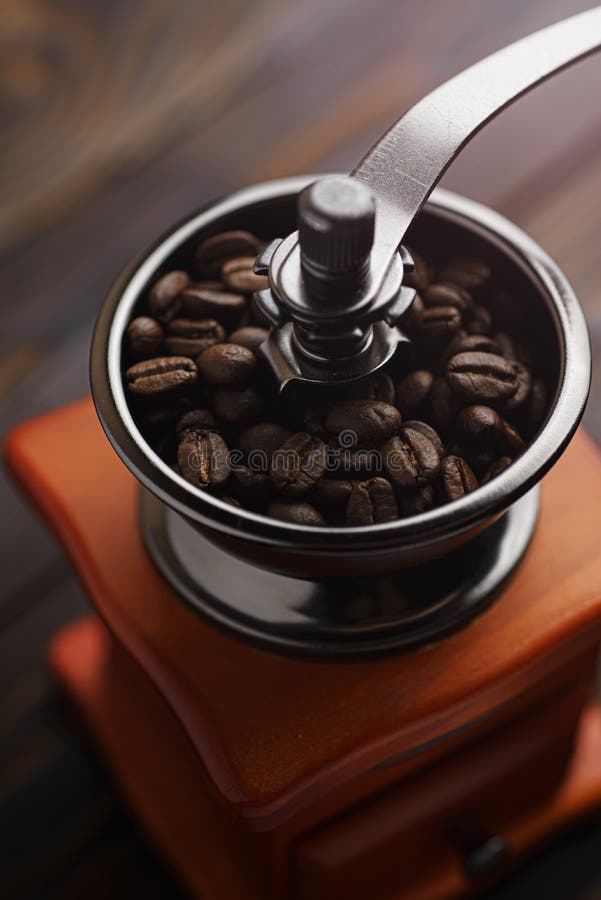 Coffee Grinder on a Wooden Table in a Rustic Style. Roasted Coffee