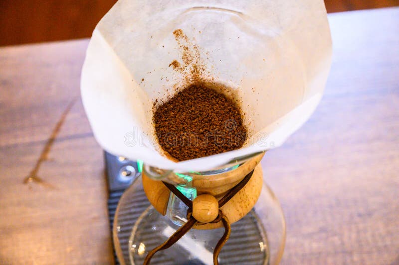 Coffee grounds in pour over filter with chemex stock photos