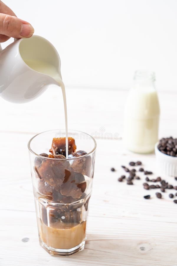 Coffee ice cubes with milk stock photo. Image of glass 136486870