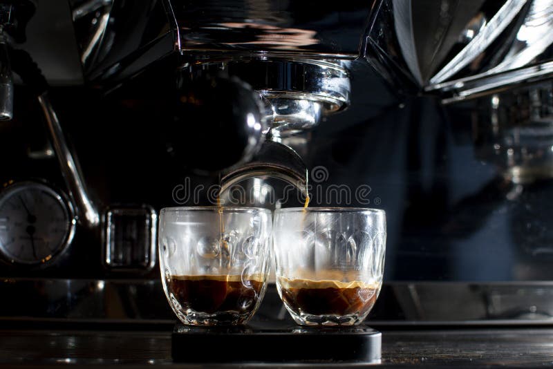Coffee Machine Makes Double Espresso in Glasses at Night, the Process of Making Coffee, Closeup