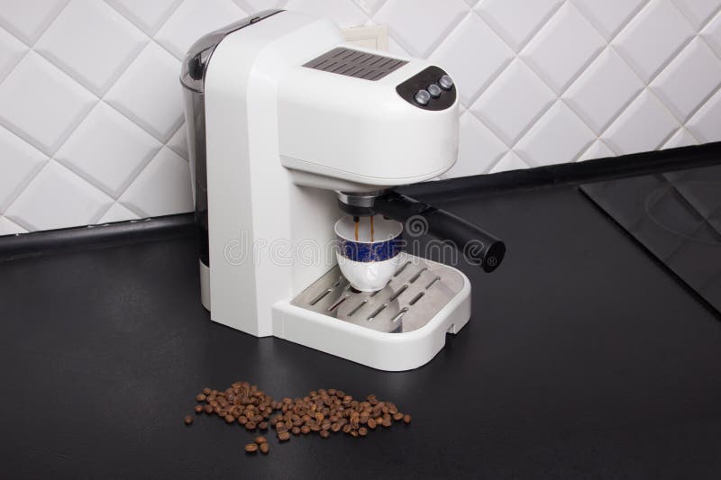 Coffee Machine Makes Espresso on Black and White Kitchen Stock Image