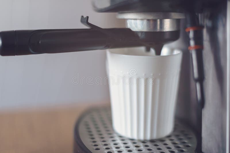 Coffee Machine Placed on a Wooden Kitchen Table at Home Makes a Strong
