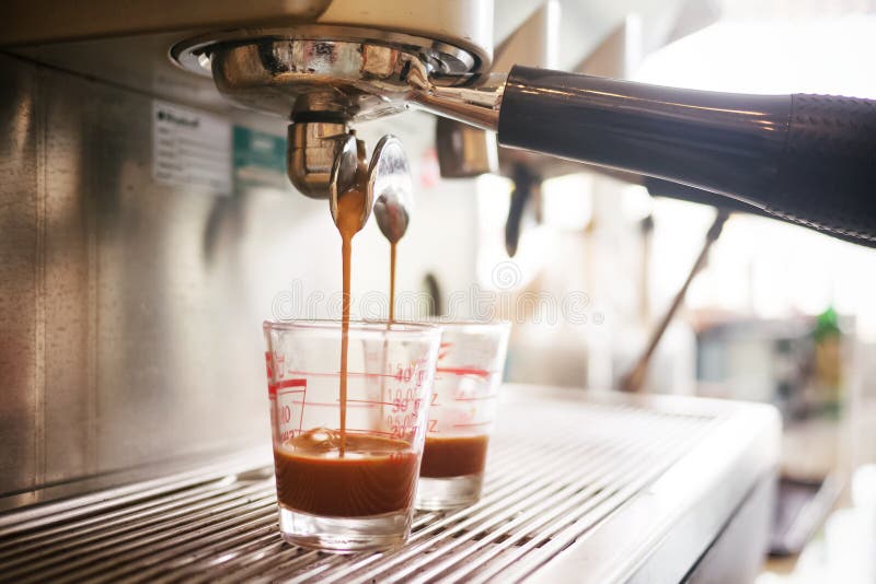 Coffee Machine Preparing Espresso and Pouring into Cups Stock Photo