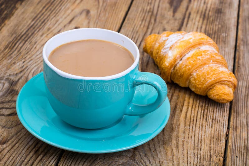 Coffee with milk, fresh pastry for breakfast. stock image