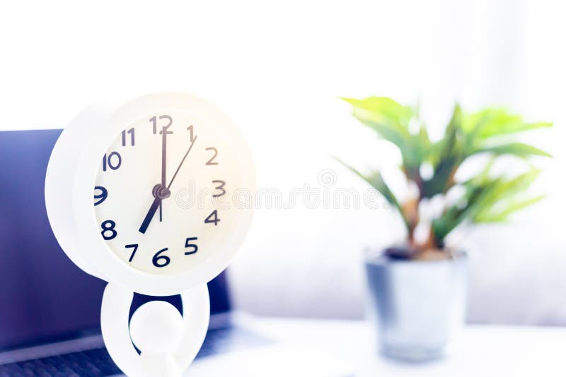 Coffee on Notebook with Laptop on White Table in the Morning Sun Light