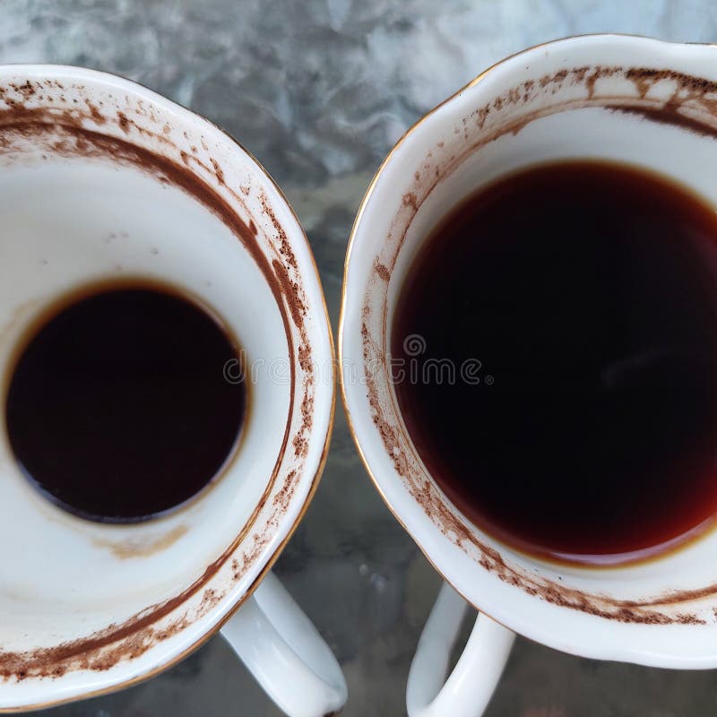 Coffee in a Partially Drunk Cup with Traces of Coffee on the Edge of