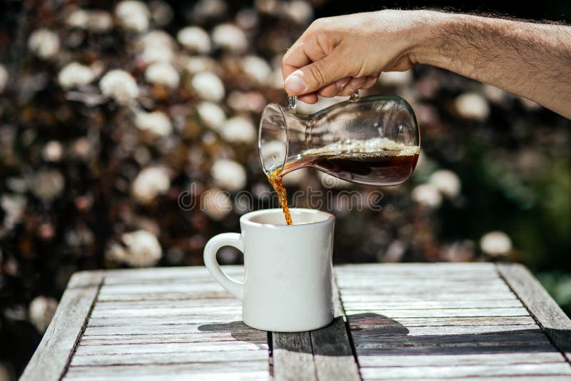 Coffee pouring to the cup stock photo. Image of clothing - 193846738
