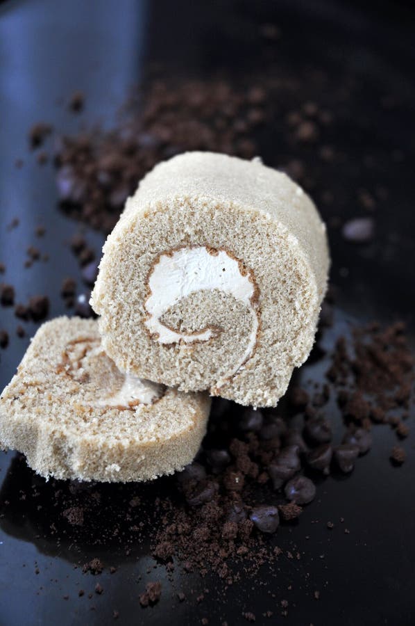 Coffee Roll Cake on Messy Background of Chocolate and Coffee Stock