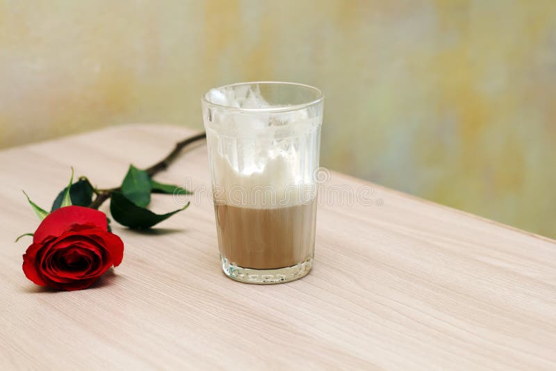 Coffee and rose on table