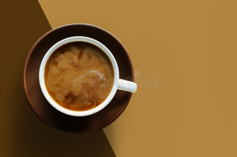 Coffee with swirl of milk or cream. Cup of morning drink, saucer on double diagonal background. Monochrome horizontal banner