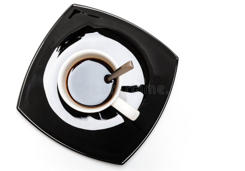 Coffee in white cup on black saucer