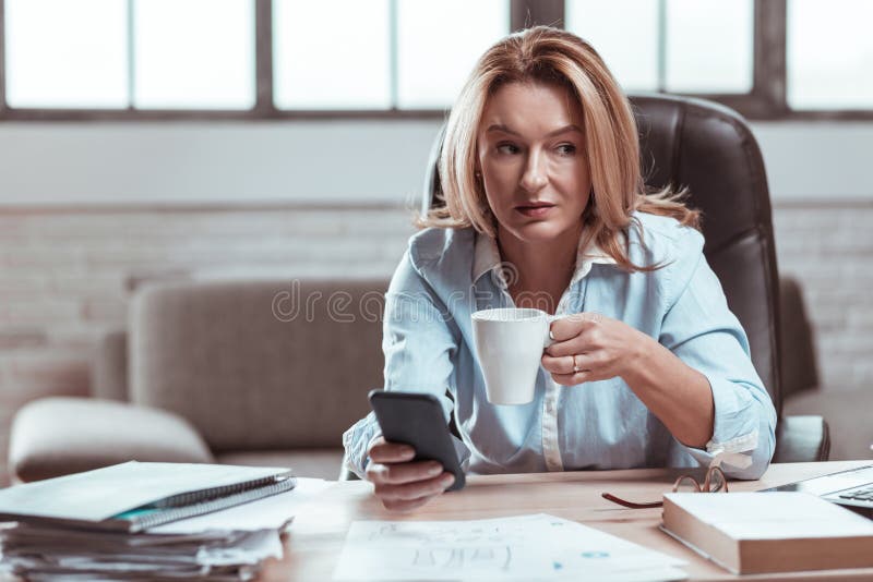 Beautiful lawyer feeling relaxed drinking some coffee at work royalty free stock photography Beautiful lawyer feeling relaxed drinking some coffee at work royalty free stock photography