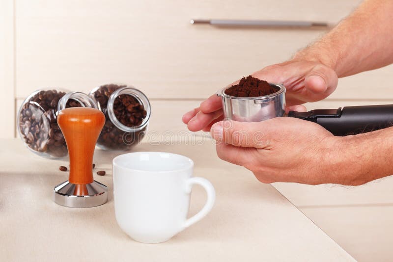Coffeemaker Levels the Ground Coffee in the Holder of Coffee Machine