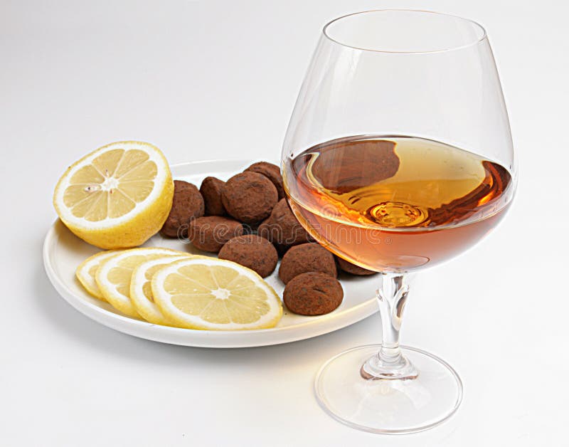 Cognac and snack,focus on a glass