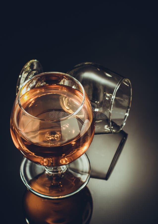 Cognac glass on black stock photo. Image of lying, goblet 99199110
