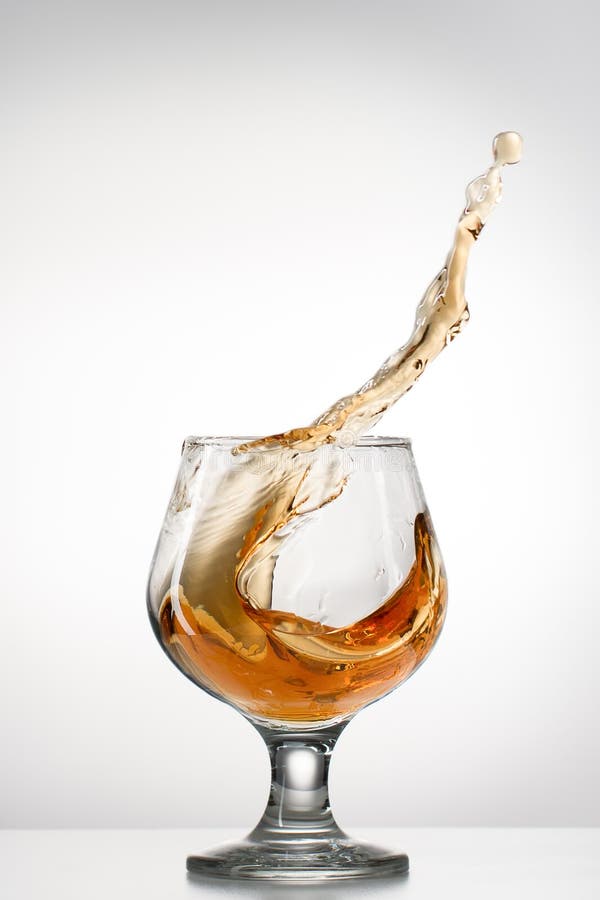 Cognac glass with splash stock photo. Image of glass 53980548