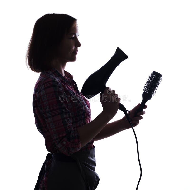 Coiffeur tenant le hairdryer et la brosse sur le backgropund blanc image libre de droits Coiffeur tenant le hairdryer et la brosse sur le backgropund blanc image libre de droits