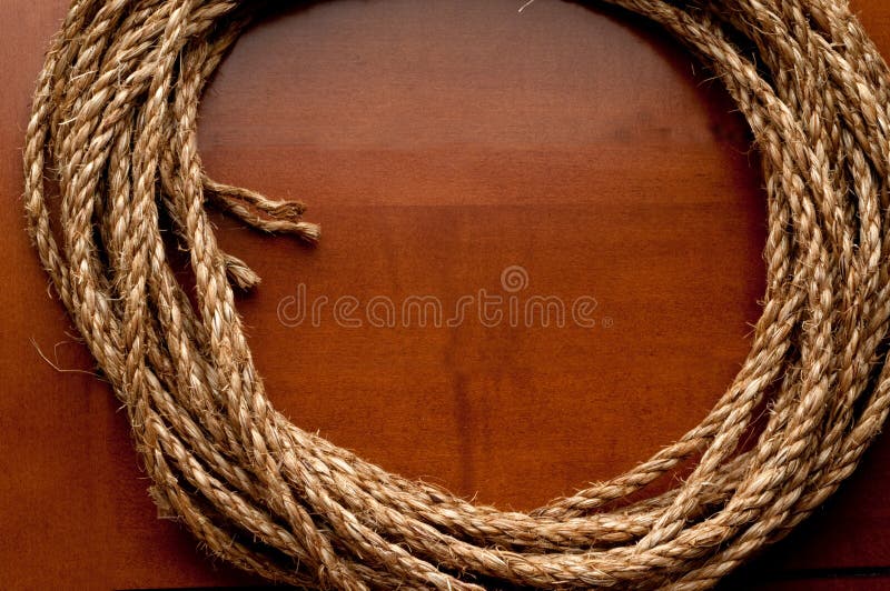 coil of rope on a wooden surface