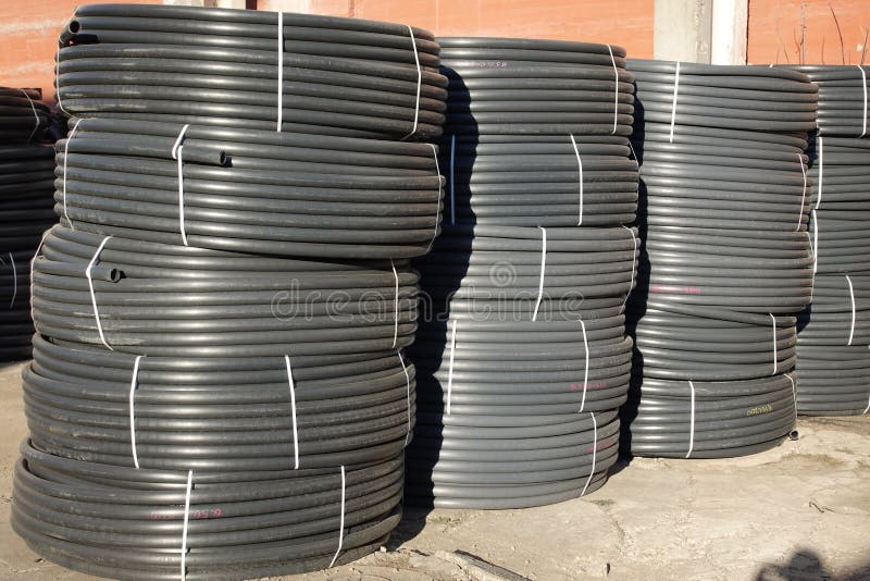 Coiled Black Plastic Pipes Stored Outdoors Stock Image Image of dusty