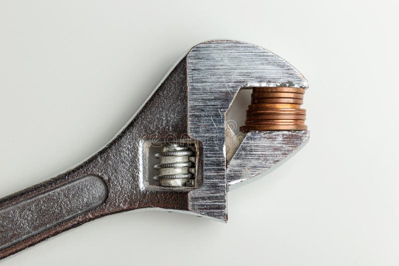 A coin clamped in a adjustable wrench